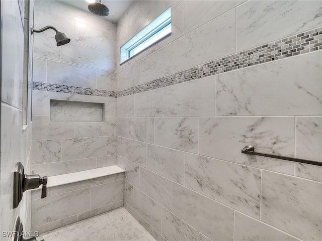 full bath featuring tiled shower