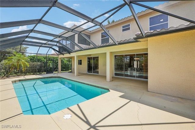 pool with glass enclosure and a patio area