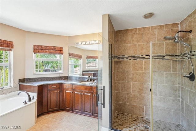 bathroom featuring a stall shower, a wealth of natural light, tile patterned flooring, and a garden tub