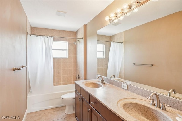full bath with visible vents, toilet, tile patterned flooring, and a sink