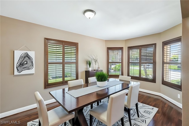 dining space with baseboards and dark wood-style flooring