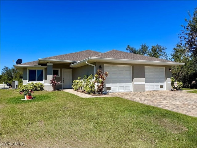 view of front of home featuring stucco siding, a front lawn, a garage, central air condition unit, and decorative driveway