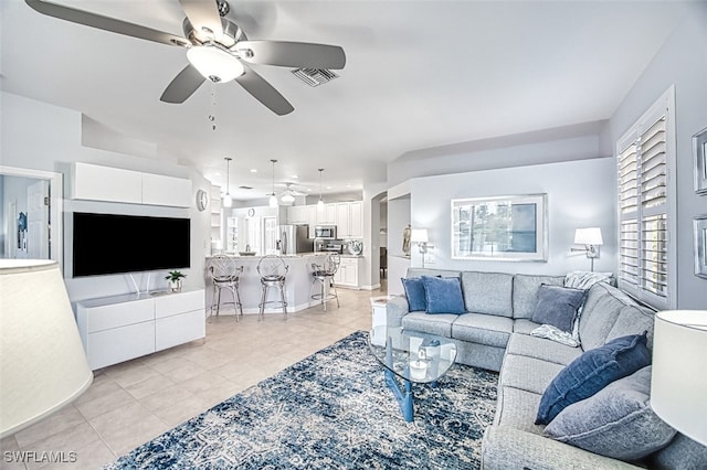 living area featuring visible vents, ceiling fan, and light tile patterned flooring