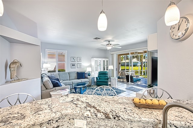 living room featuring visible vents and ceiling fan