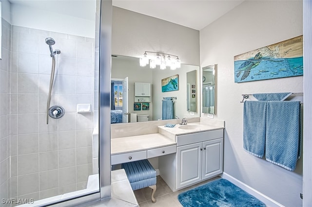 ensuite bathroom with vanity, tile patterned floors, a tile shower, and connected bathroom