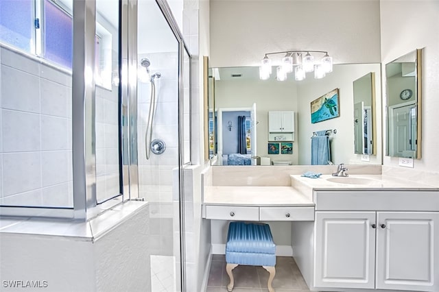 bathroom featuring a tile shower, tile patterned flooring, connected bathroom, and vanity