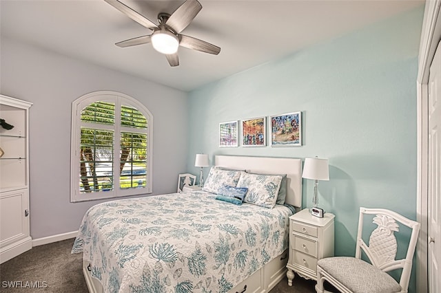 bedroom with baseboards, a ceiling fan, and dark colored carpet