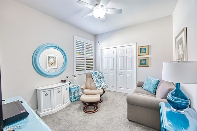 carpeted living room featuring a ceiling fan