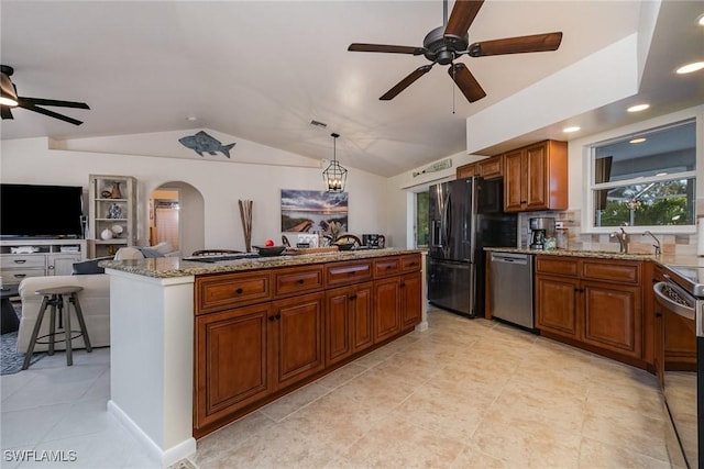 kitchen with brown cabinets, stainless steel dishwasher, open floor plan, arched walkways, and black refrigerator with ice dispenser