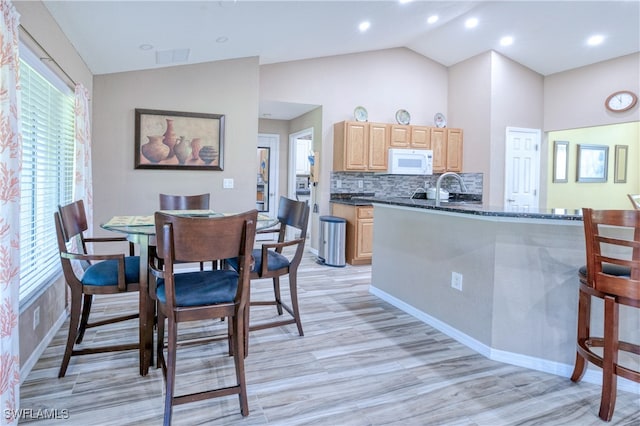 dining room featuring recessed lighting, visible vents, lofted ceiling, and light wood-style floors