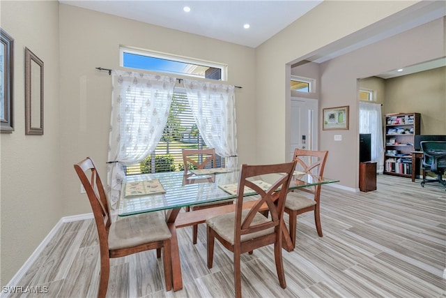 dining room featuring recessed lighting, light wood-style flooring, and baseboards