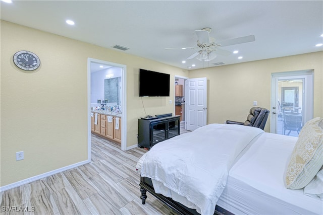 bedroom featuring baseboards, visible vents, ensuite bathroom, and light wood-type flooring