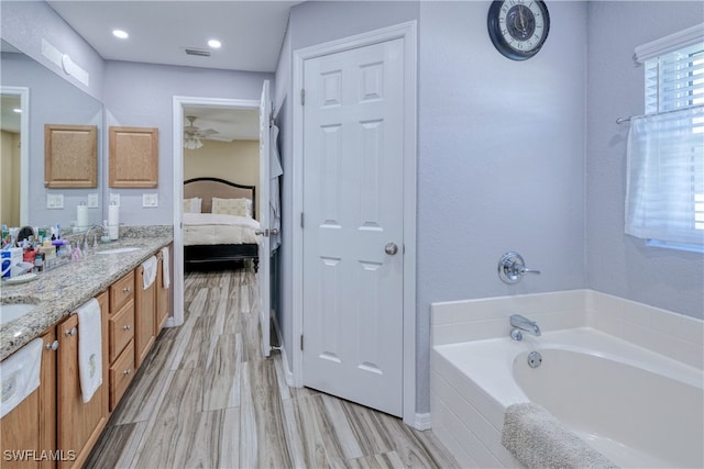 bathroom with visible vents, a garden tub, a sink, connected bathroom, and double vanity