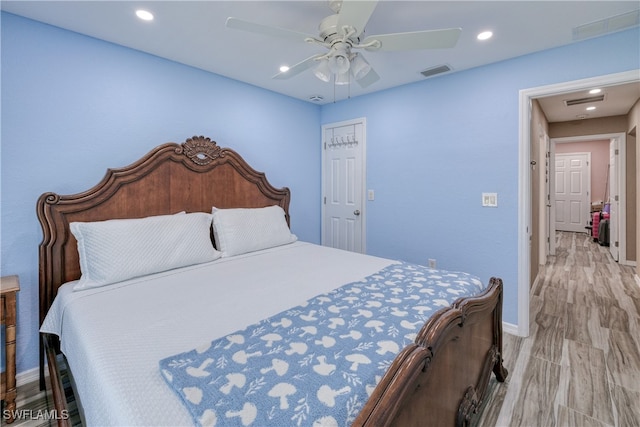 bedroom with visible vents, a ceiling fan, recessed lighting, light wood-style floors, and baseboards