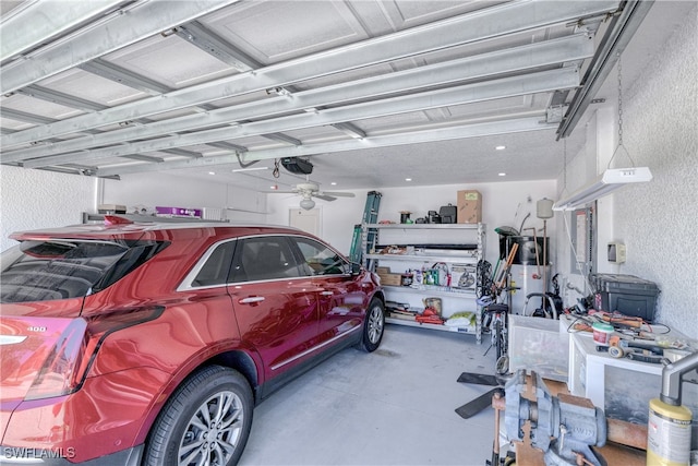 garage with gas water heater, a textured wall, a garage door opener, and ceiling fan