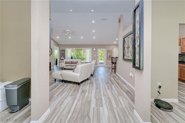 living room featuring recessed lighting, a ceiling fan, baseboards, and light wood finished floors