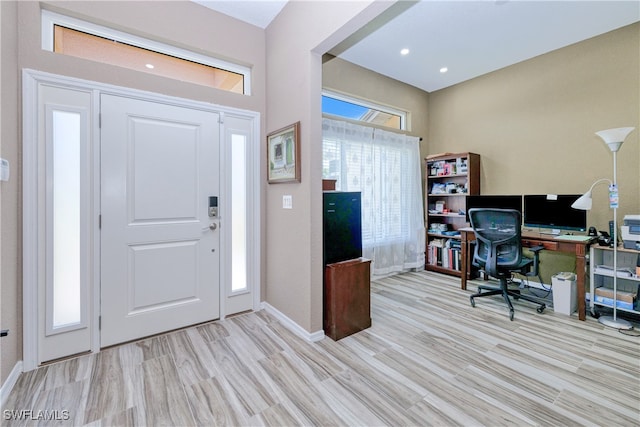 entryway with wood finished floors and baseboards