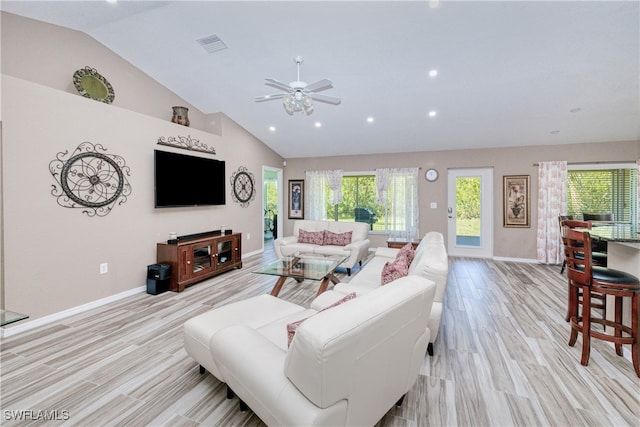 living area featuring a wealth of natural light, visible vents, light wood-type flooring, and a ceiling fan