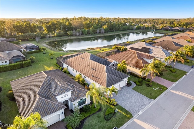 drone / aerial view featuring a water view and a residential view