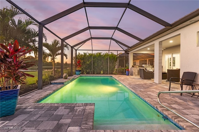 pool featuring an outdoor kitchen and a patio area