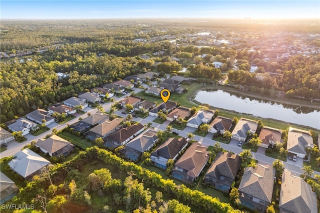 birds eye view of property with a residential view and a water view