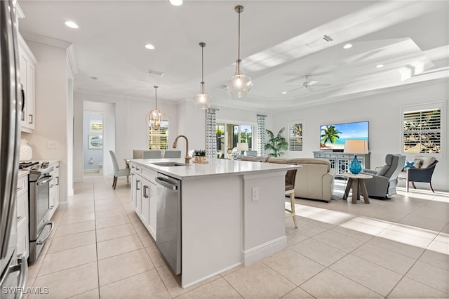 kitchen with light tile patterned flooring, a sink, light countertops, appliances with stainless steel finishes, and crown molding