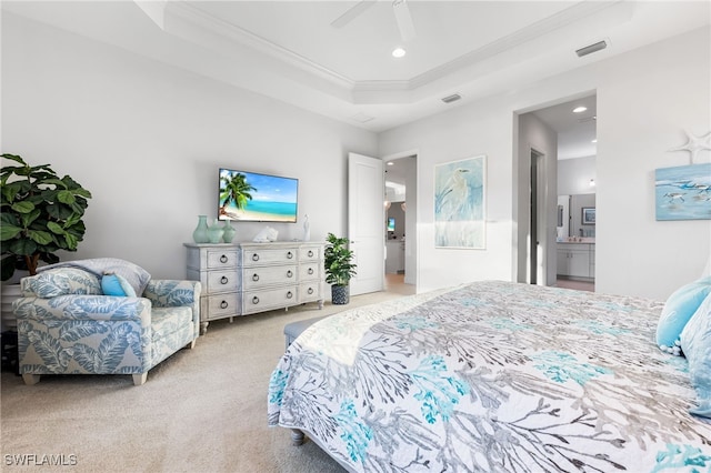 bedroom with visible vents, ornamental molding, connected bathroom, carpet, and a raised ceiling