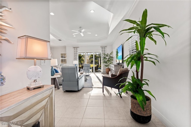 13589 Starwood Ln, Fort Myers, FL 33912 - living room with a ceiling fan, a tray ceiling, light tile patterned flooring, recessed lighting, and crown molding