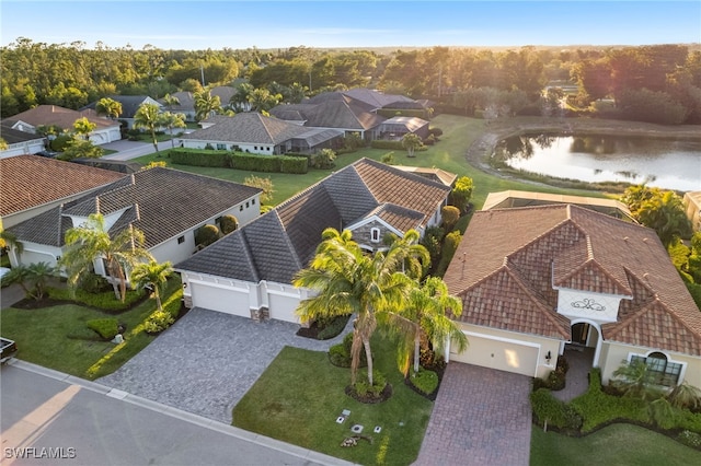 drone / aerial view featuring a residential view and a water view