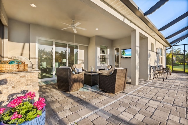 view of patio / terrace featuring glass enclosure, area for grilling, and ceiling fan