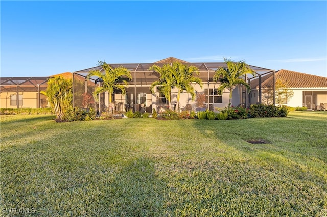 view of front of home with a front yard, a lanai, and stucco siding