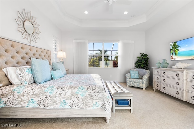 bedroom with ceiling fan, a tray ceiling, ornamental molding, light carpet, and recessed lighting