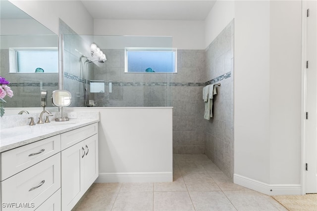 full bath featuring vanity, a healthy amount of sunlight, and a walk in shower