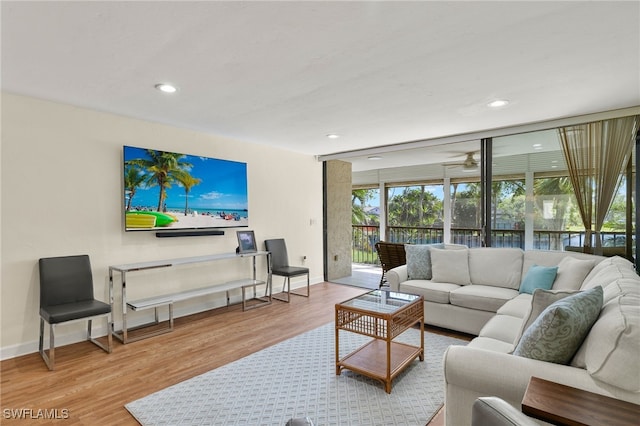 living room featuring recessed lighting, ceiling fan, baseboards, and wood finished floors