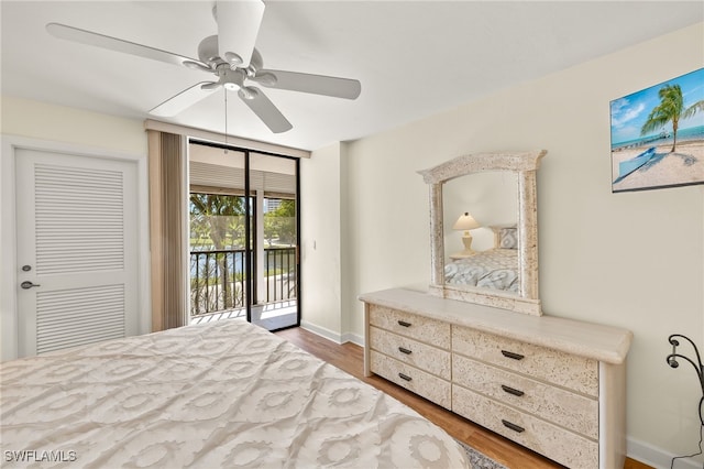 bedroom with a ceiling fan, access to outside, wood finished floors, and baseboards