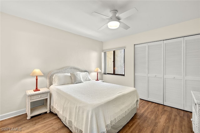 bedroom with a ceiling fan, wood finished floors, a closet, and baseboards