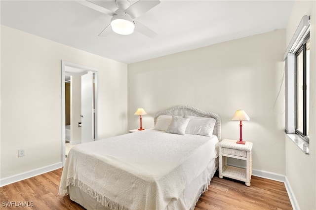 bedroom with ceiling fan, baseboards, and wood finished floors