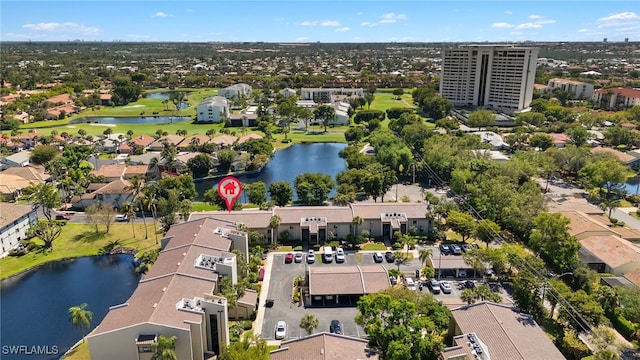 drone / aerial view with a residential view, a water view, and view of golf course