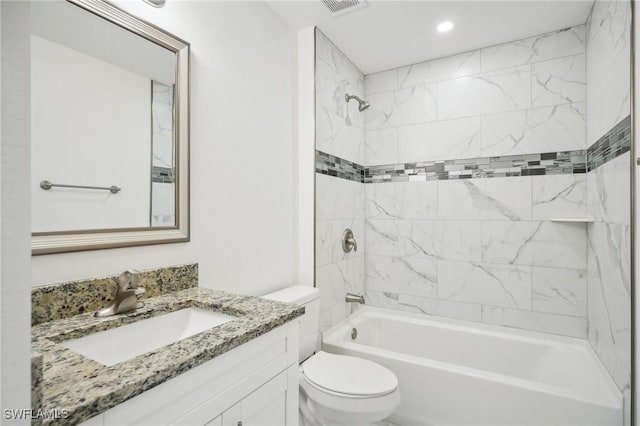 bathroom with visible vents, toilet, bathtub / shower combination, and vanity