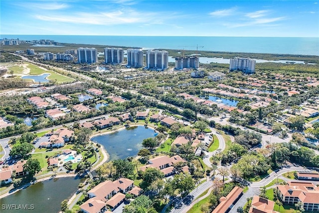 drone / aerial view with a city view and a water view