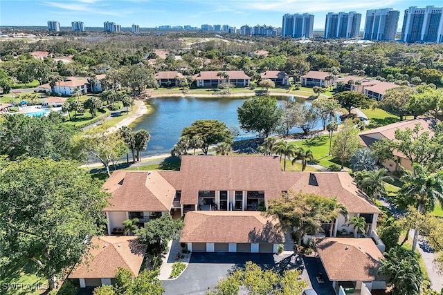 birds eye view of property with a water view and a view of city