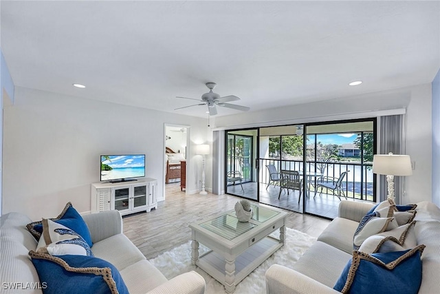 living area featuring recessed lighting, baseboards, wood finished floors, and a ceiling fan