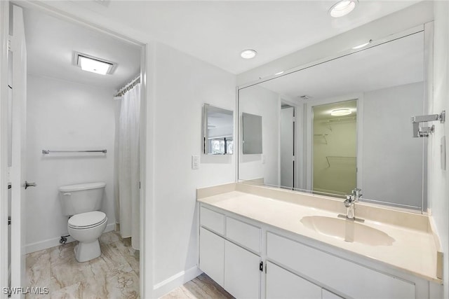 full bath featuring a walk in closet, toilet, recessed lighting, baseboards, and vanity