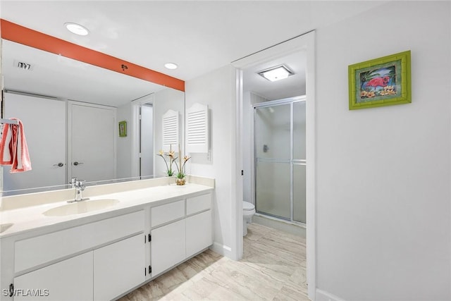 full bath featuring vanity, toilet, a stall shower, and marble finish floor