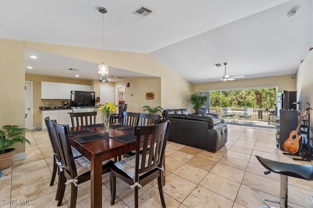 dining space with light tile patterned floors, visible vents, a ceiling fan, and lofted ceiling