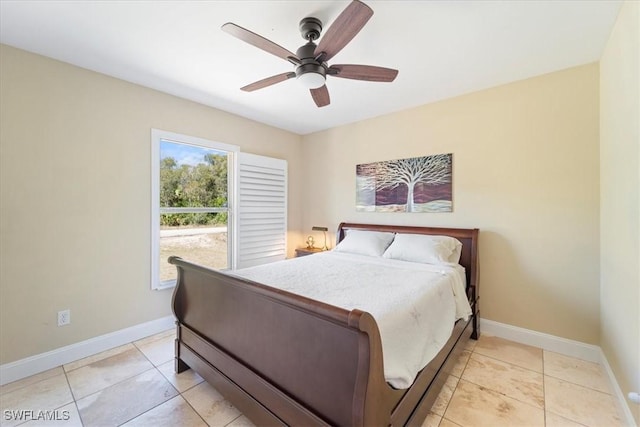 bedroom featuring light tile patterned floors, baseboards, and ceiling fan