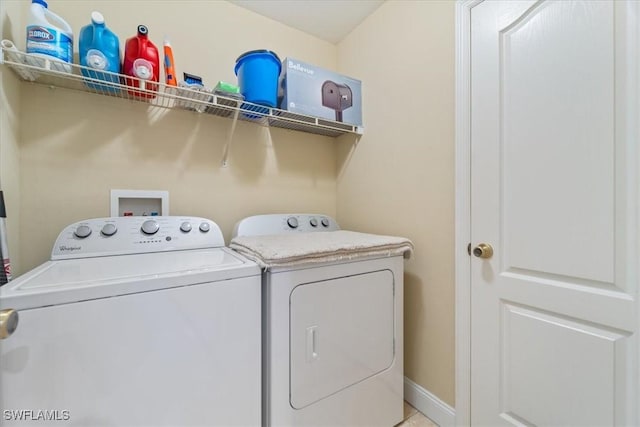 laundry area featuring laundry area, baseboards, and independent washer and dryer