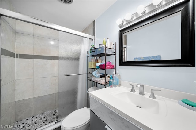 full bathroom with a shower stall, toilet, and vanity