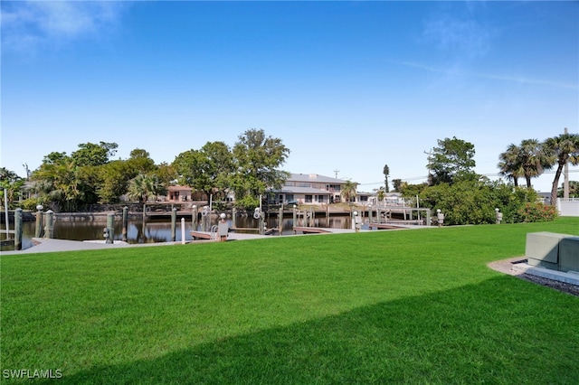 view of yard with a dock and a water view