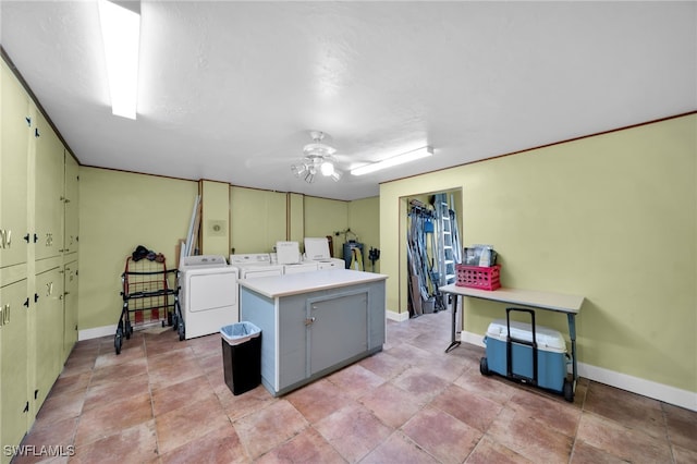 laundry area featuring baseboards, cabinet space, separate washer and dryer, and ceiling fan